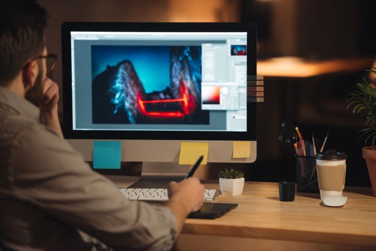 graphicstock-young-concentrated-bearded-web-designer-dressed-in-shirt-working-late-at-night-and-looking-at-computer_BU7eneYQ_3e