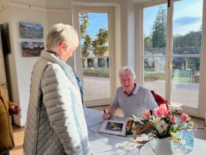 Nigel McCall signing one of his new books for a Member of the Gardens at the launch event