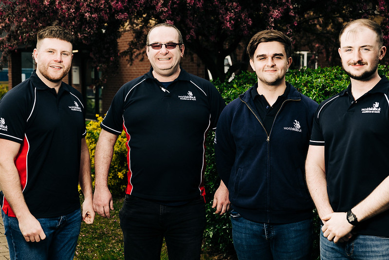 Mike George (far left) and George Denman (second right) with their tutor and teammate