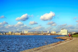 water, sea, sky, travel, panoramic, cardiff, cardiff bay, barrage, city, millennium stadium, sunlight, blue sky, nature, scene, light, ocean, architecture, landscape, panorama, blue, summer, tourism, scenic, sunny, outdoor, cloud, colorful, europe, landmark
