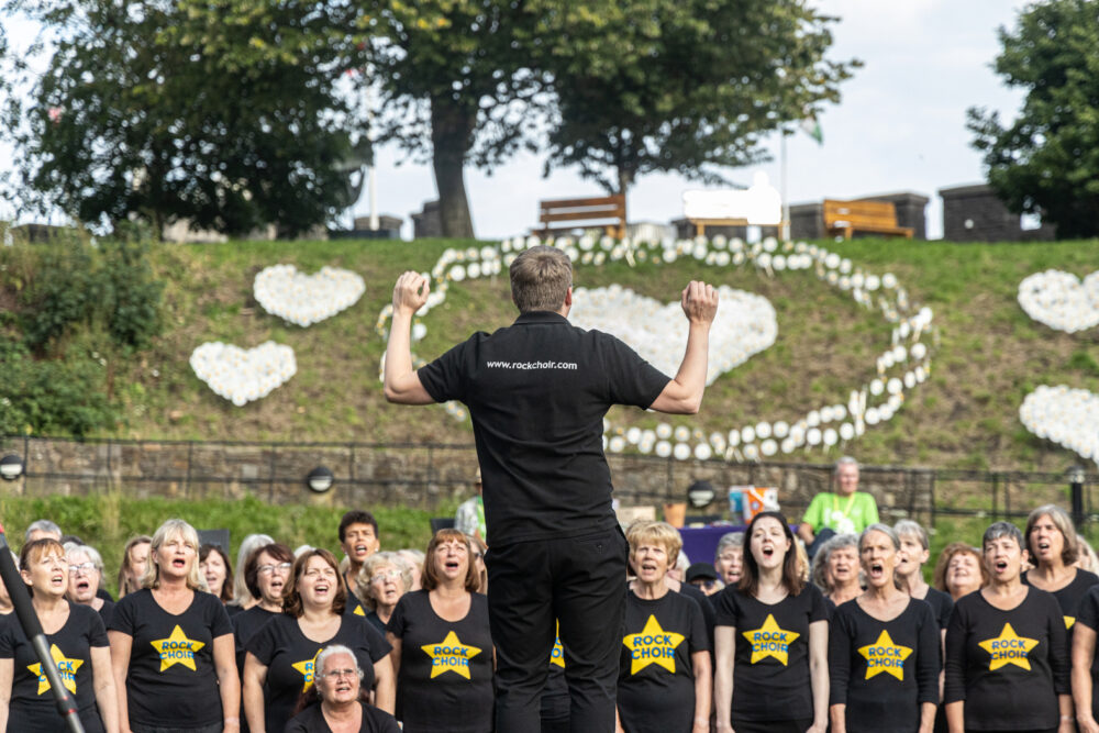 A 300 strong super rock choir performed in front of the Forever Flowers display