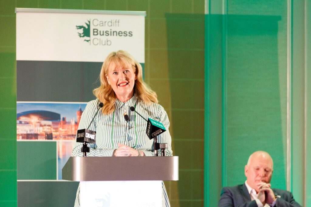 Woman standing at a podium giving a speech