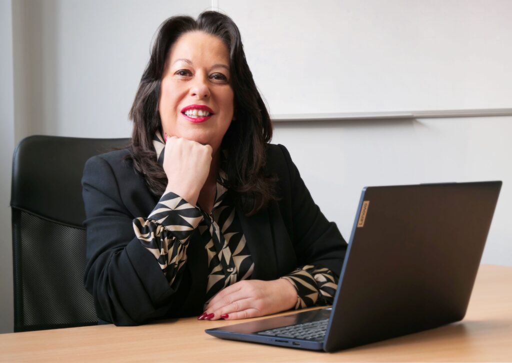 Woman sat at a desk in front of a laptop