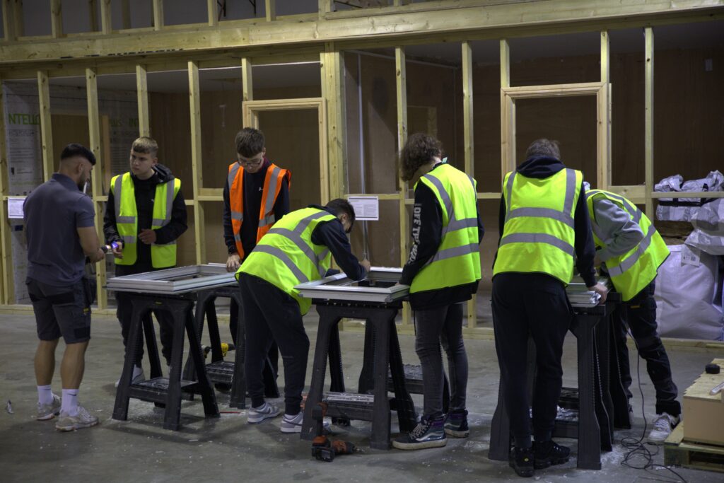 A group of apprentices at Consumer Energy Solutions working wearing high vis jackets.