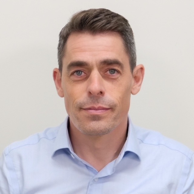 Headshot of David Pena wearing a blue shirt.