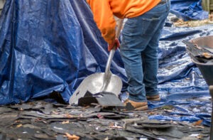 cleaning up debris from a roofing job