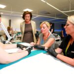 First Minister praise for £14m health complex and new Welsh language centre of excellence on North Wales visit