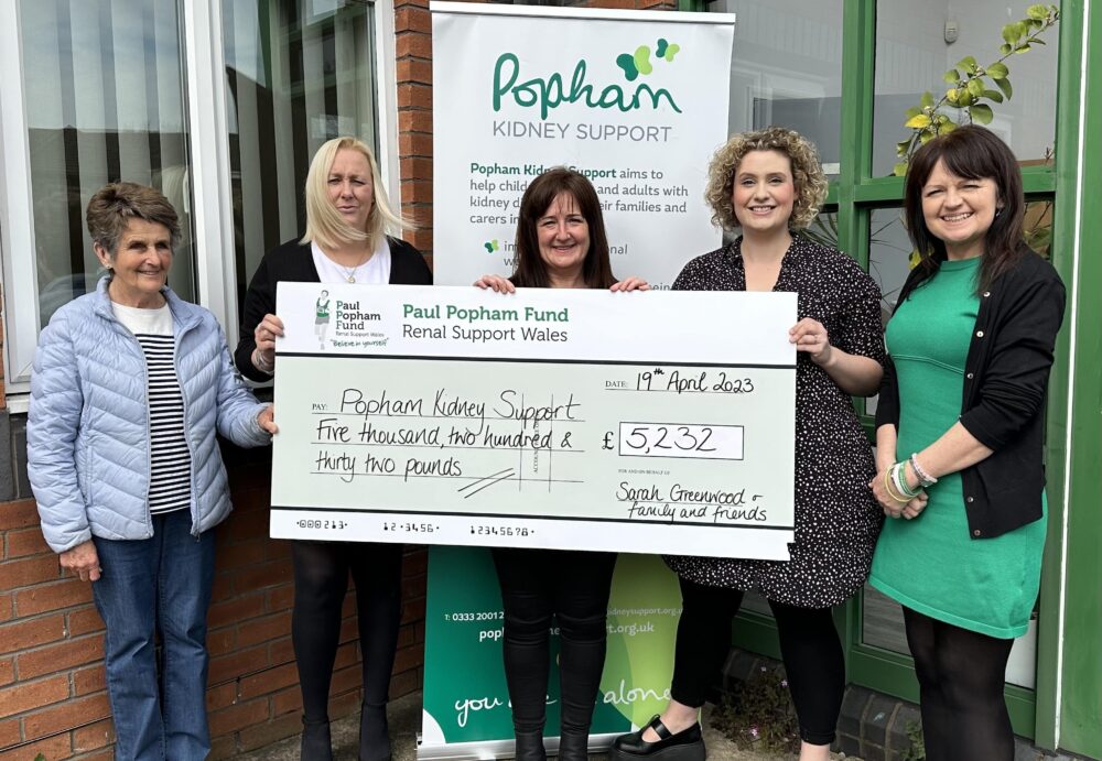 Fundraiser Sarah Greenwood (middle), presenting a cheque to members of the Popham Kidney Support team