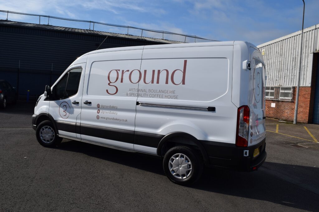 A white van with the logo for 'ground' written across the side.