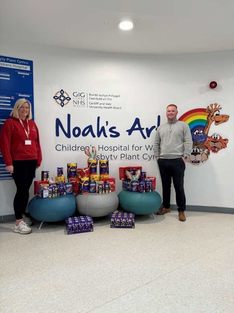 A man and woman standing with Easter eggs