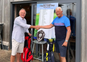 Popham Kidney Support Golf Day organiser, Kim Loosmore (left), presenting the winner's trophy to The Secret Beach Bar & Kitchen in Swansea