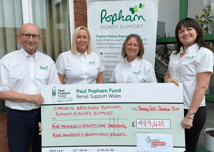 Popham Kidney Support team members Geraint John, Hayley Evans, Gail Williams and its CEO, Joanne Popham, with the cheque presented by the National Lottery