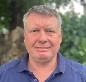 Headshot of a man standing outside