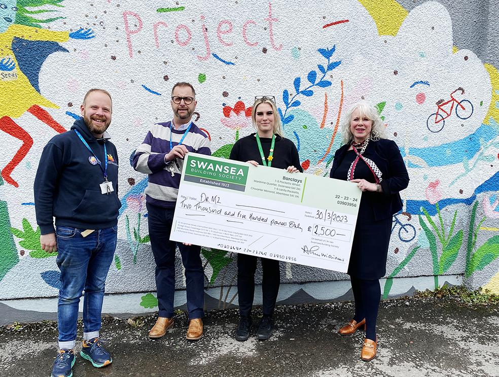 Sioned Jones (right), Area Manager Swansea Building Society West Wales, hands over a cheque for £2,500 to representatives of Carmarthen Youth Project, Dr Mz