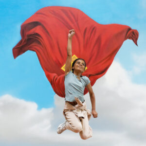A child jumping in a Superman pose in front of the mural in The Red Dragon Centre
