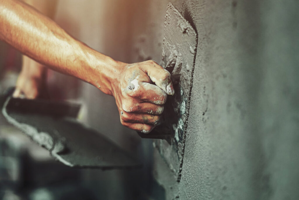 closeup-hand-worker-plastering-cement-wall-building-house