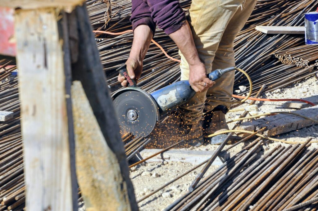 a man using a circular saw to cut a piece of wood