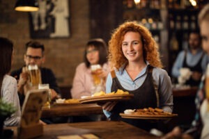 happy-redhead-waitress-serving-customers-restaurant-bringing-food-their-table