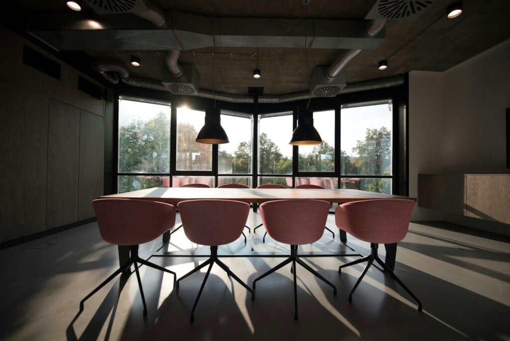 pink dining table with four chairs inside room