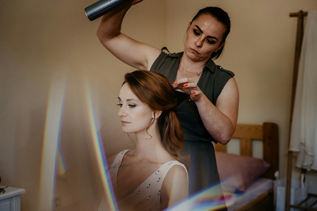 woman in black sleeveless dress holding hair dryer