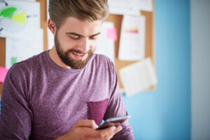 man-purple-clothes-using-his-phone