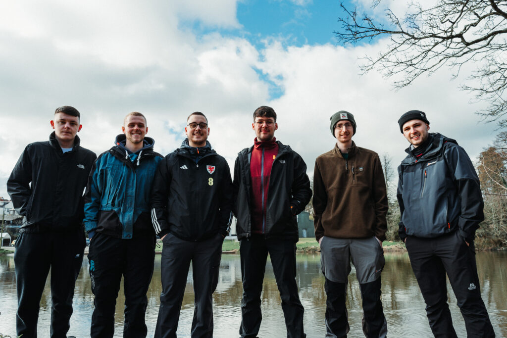 the six friends standing outside in their training and hiking gear