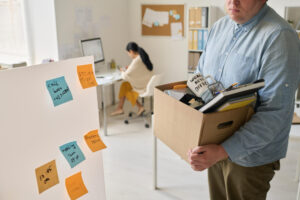 young-businessman-carrying-box-with-things-after-layoff-he-leaving-office